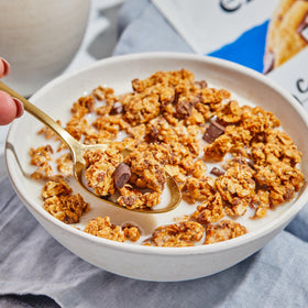 Purely Elizabeth cookie granola chocolatechip 11oz bag product shot on shelf communicates grab-and-go snack.