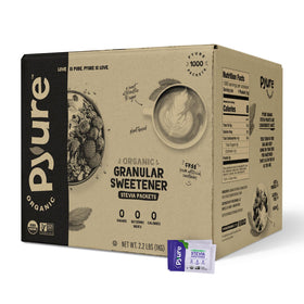 Pyure Organic Stevia Packets beside a steaming coffee cup for keto-friendly sweetness.