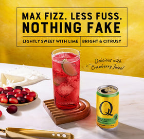Q Mixers tonic water with lime pour over glass showcasing versatile mixer for cocktails
