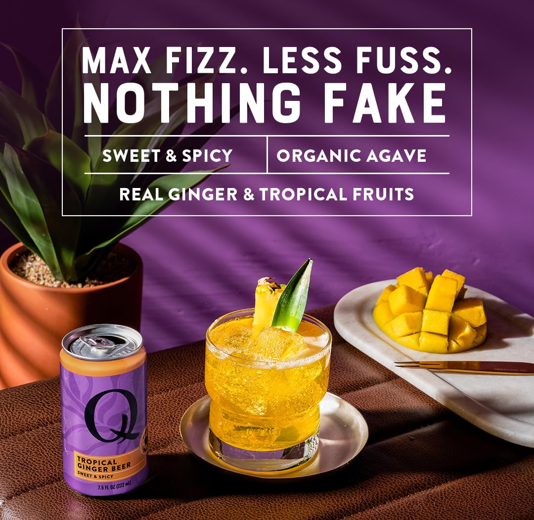 Glass of Q Tropical Ginger Beer with citrus wedges for a lively cocktail base.