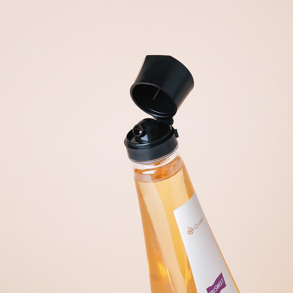 q.one Trusweet syrup bottle on the kitchen counter with a measuring cup
