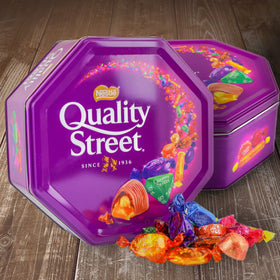 Quality Street decorative tin opened to reveal chocolates, ideal for sharing at family gatherings