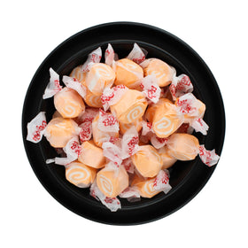 Chewy, soft texture visible in orange-and-white taffy for Easter egg hunts