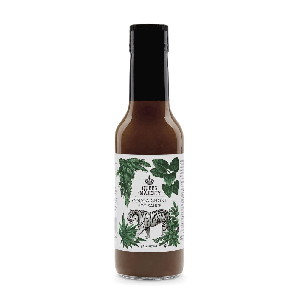 Queen Majesty Cocoa Ghost Hot Sauce bottle on a kitchen counter, previewing a bold chocolate-pepper flavor.