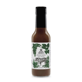 Queen Majesty Cocoa Ghost Hot Sauce bottle on a kitchen counter, previewing a bold chocolate-pepper flavor.