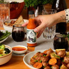 Queen Majesty hot sauce label closeup showcases artisanal ingredients and fair trade ethos