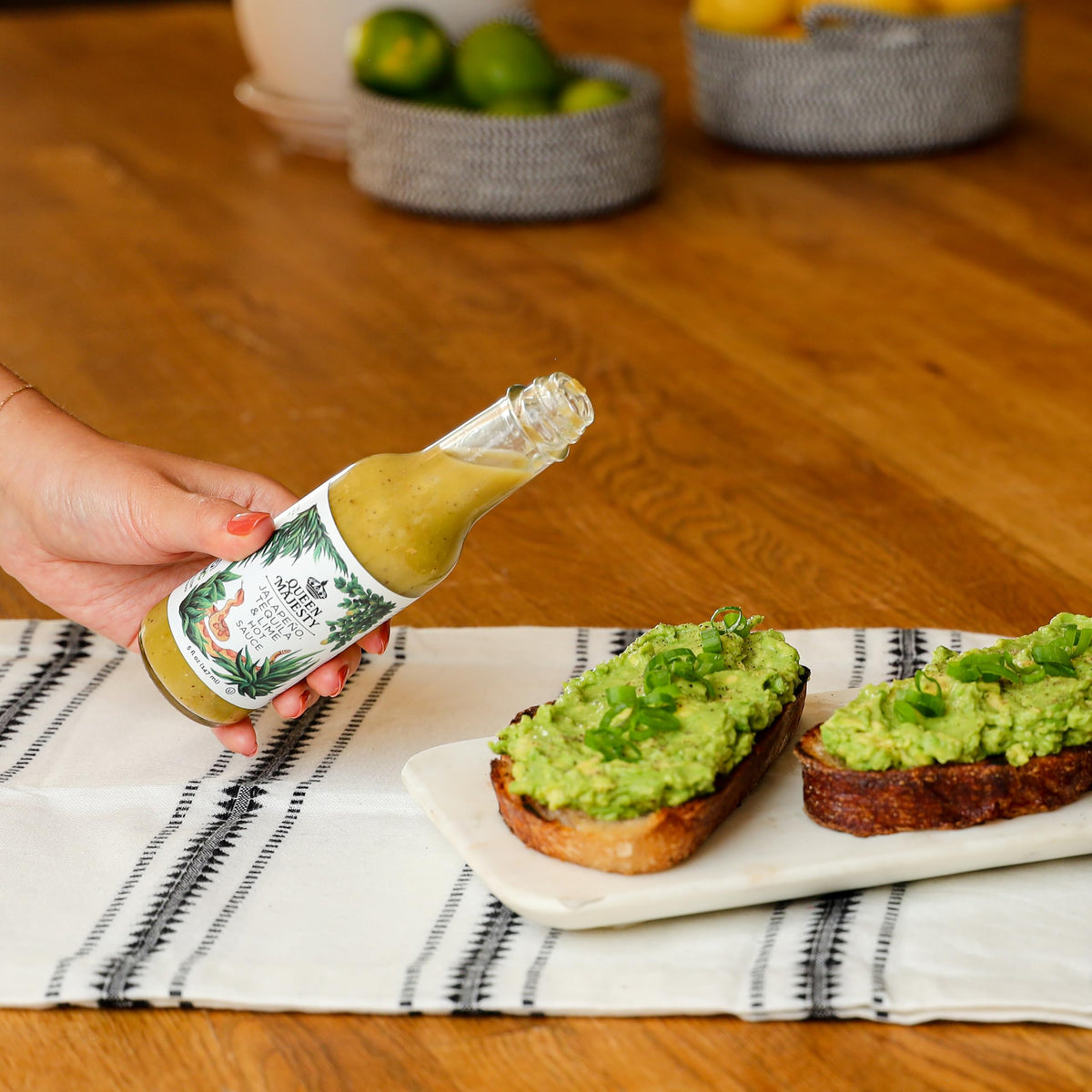 Pour shot of Queen Majesty Jalapeño Tequila and Lime hot sauce shows vibrant color.