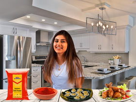 Rani Kashmiri Chilli Powder being sprinkled on a dish to boost color