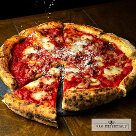 Raw Essentials Asiago Cheese Powder sprinkled on pizza for savory depth