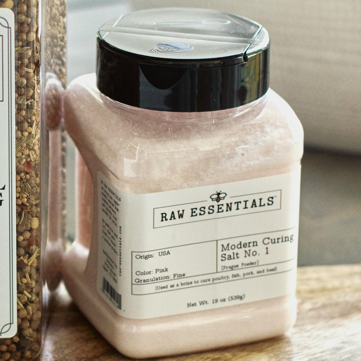 Raw Essentials jerky curing preparation with bottle and spices