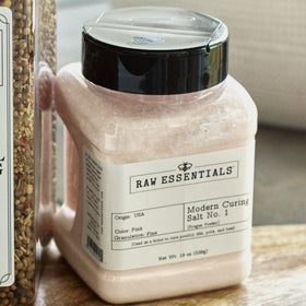 Raw Essentials jerky curing preparation with bottle and spices