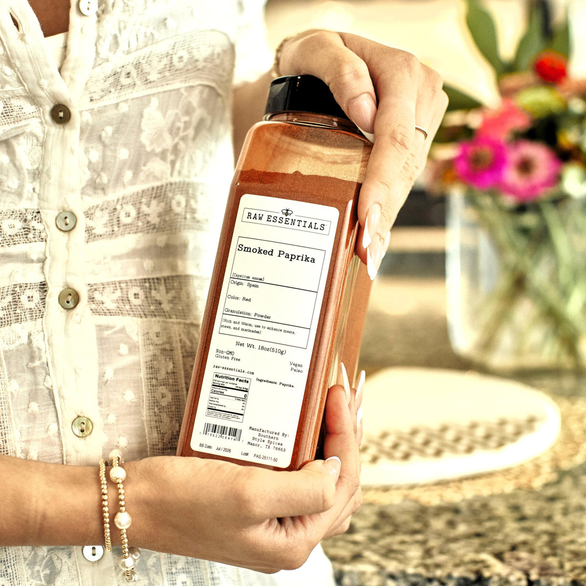 Raw Essentials smoked paprika powder spoon captures versatile seasoning for marinades and grills.