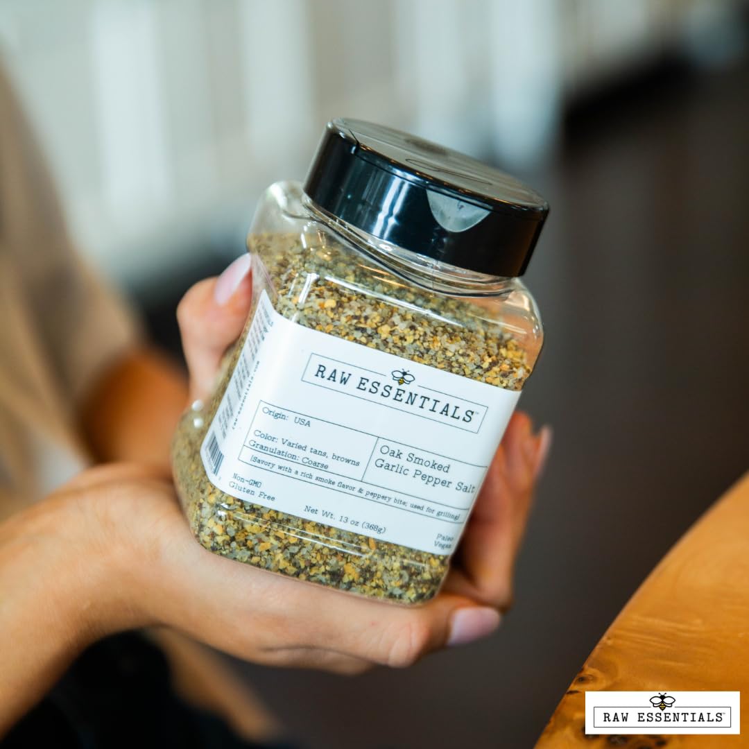 Raw Essentials seasoning bottle beside a grill-ready dish and vegetables.