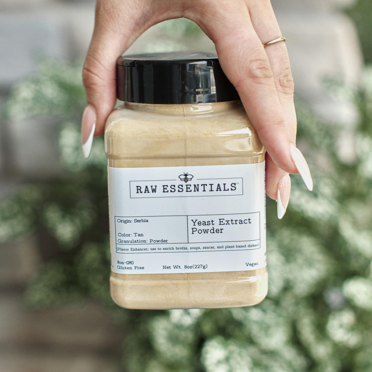 Raw Essentials yeast extract powder packaging and measuring scoop shown for precise dosing.