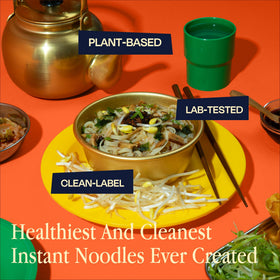 Rawmyun superfoods mix in the cup, colorful herbs and vegetables visible.