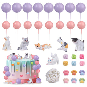 RAYNAG cat toppers collection on a cake, showing playful feline figurines for a cat-themed party