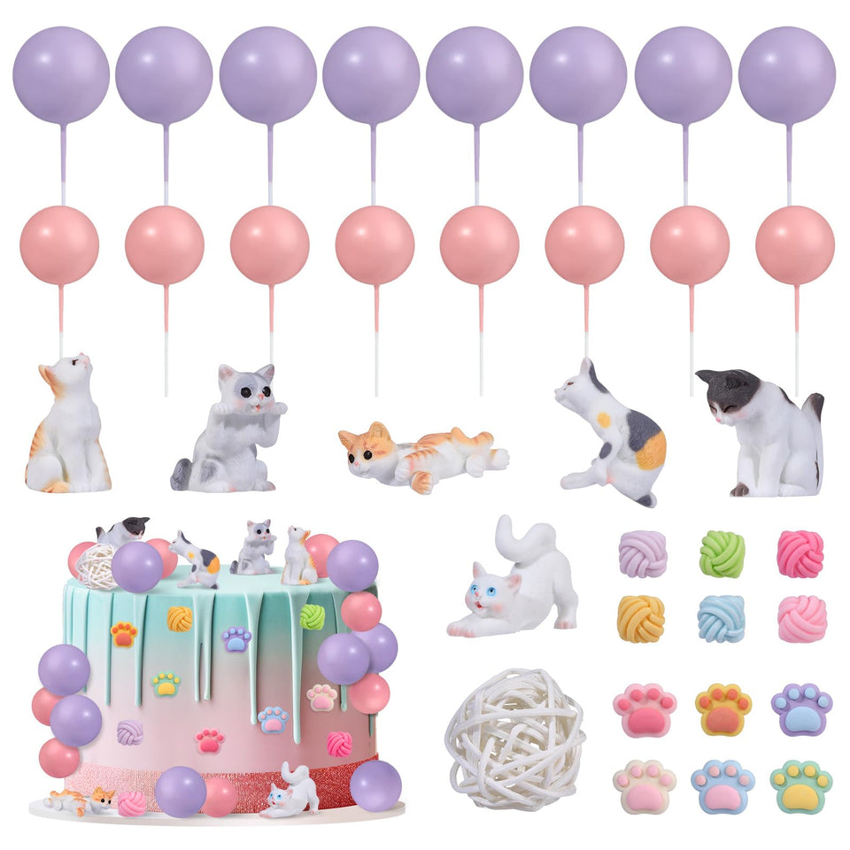 RAYNAG cat toppers collection on a cake, showing playful feline figurines for a cat-themed party