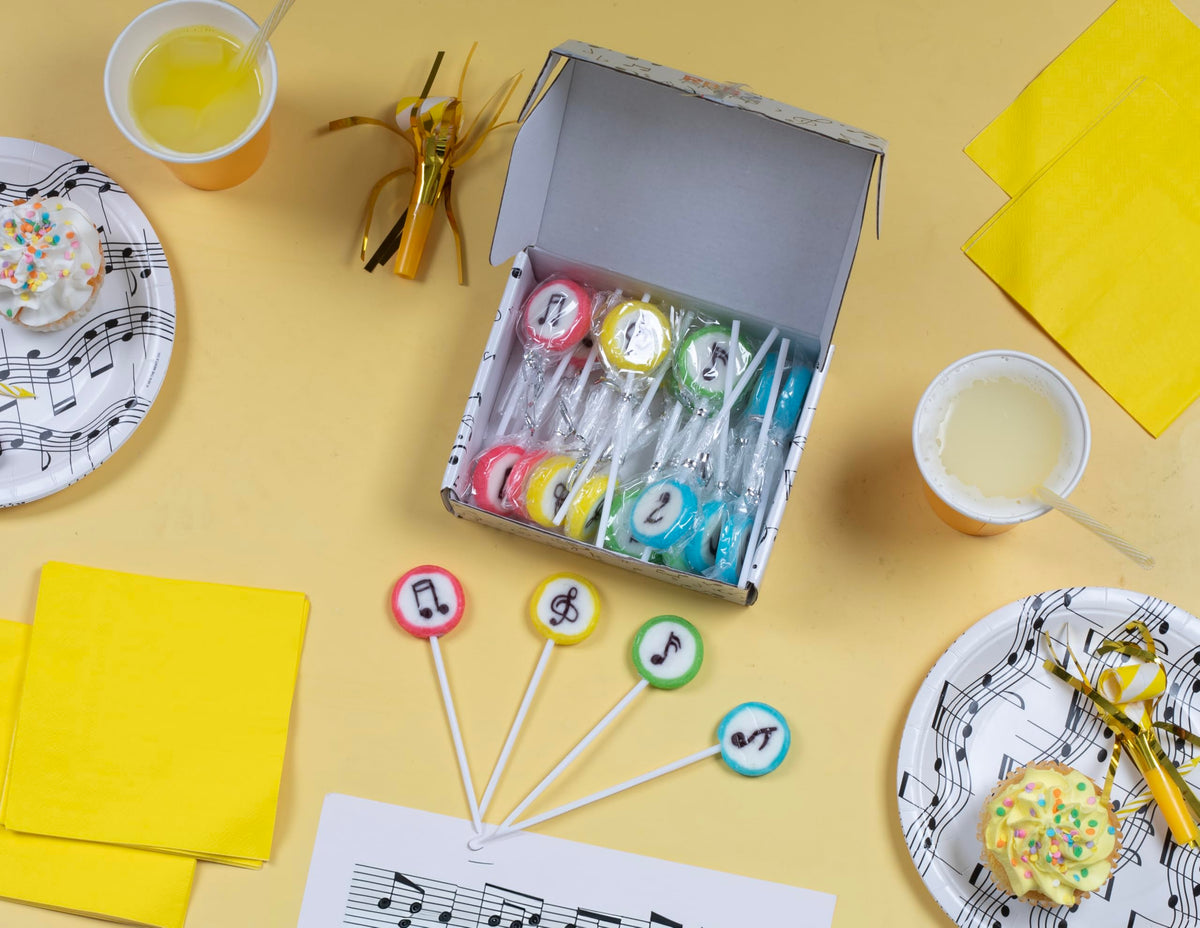 RBBZ Party classroom-favor setup with music-themed lollipops.