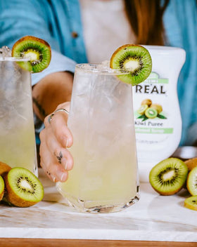 Reàl Infused Exotics passion fruit bottle pour offers bright aroma for refreshing beverages.
