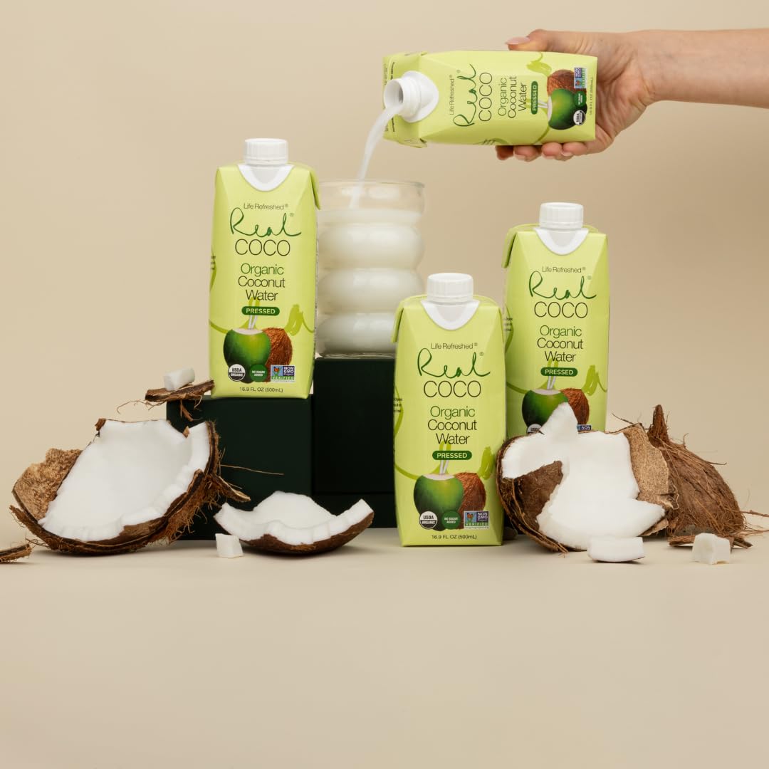 Real Coco pressed coconut water served in a glass for refreshing hydration.