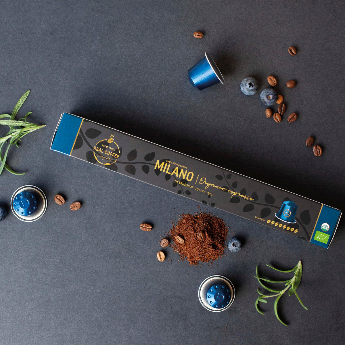 Real Coffee Milano capsules closeup showing robust crema and premium Arabica.