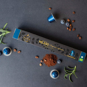 Real Coffee Milano capsules closeup showing robust crema and premium Arabica.