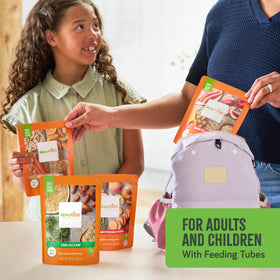 Real Food Blends Variety Pack on kitchen counter, everyday tube-feeding convenience.
