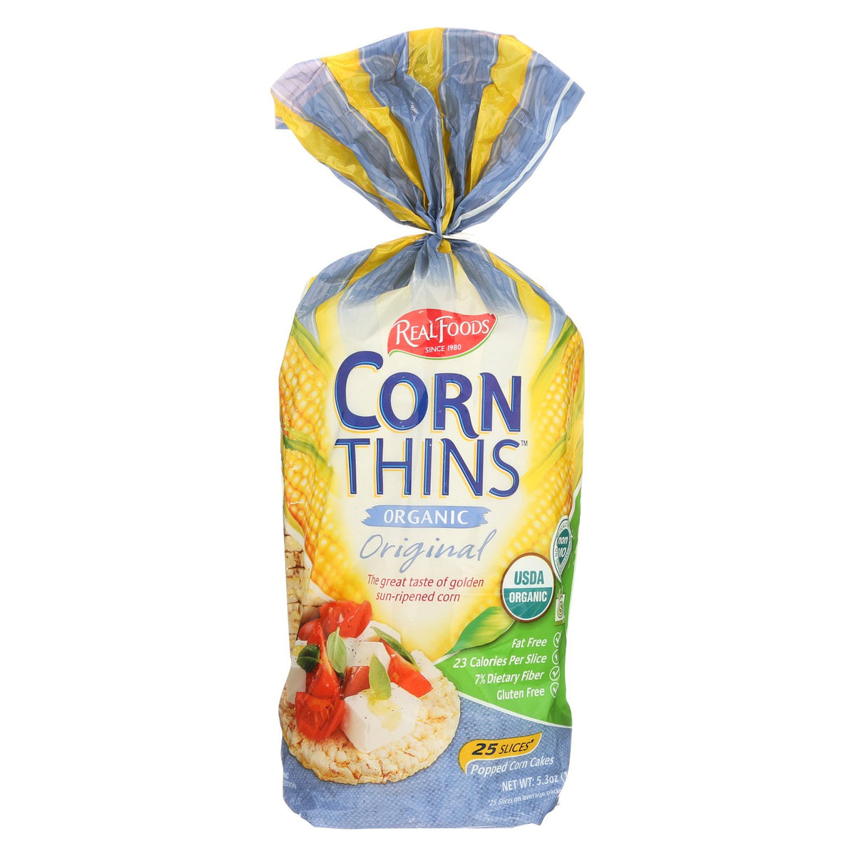 Real Foods Organic Corn Thins packaging shows a compact six-pack, ideal for on-the-go snacking.
