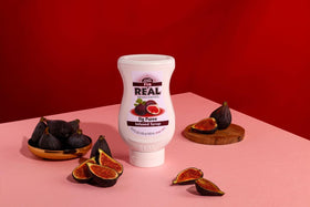 Reàl Infused Exotics Fig Puree Syrup bottle pouring for desserts.