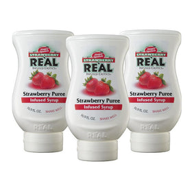 Reàl Infused Exotics Strawberry Puree bottle closeup for versatile cocktails.