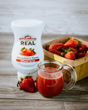 Reàl Infused Exotics bottle label highlighting fresh California strawberries.