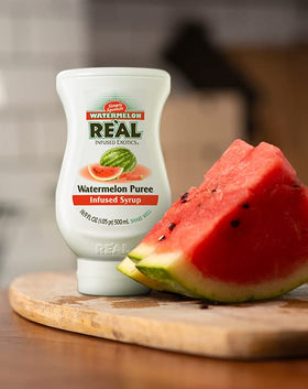 Reàl Infused Exotics Watermelon Syrup being poured for a mocktail