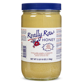 Really Raw Honey jar shows honeycomb and pollen inclusions, highlighting natural richness.