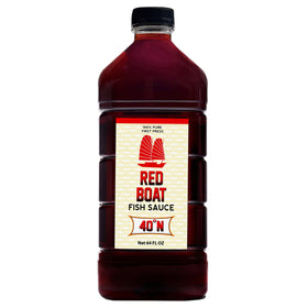 Red Boat Fish Sauce 64oz bottle ready for kitchen use, rich umami.