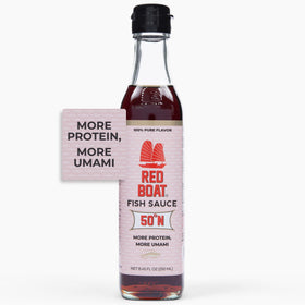 Red Boat Phamily Reserve bottle pouring, enhancing sauces with rich umami.