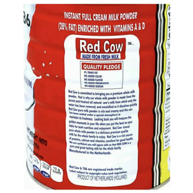 Red Cow milk powder being poured into a glass for a smooth beverage.
