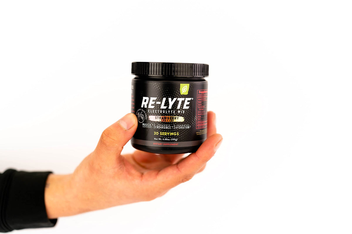 Athlete using Redmond Re-Lyte during a workout for quick refreshment.