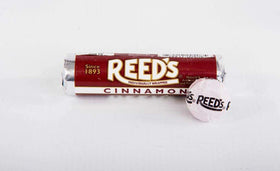 Close-up of Reed’s Root Beer Candy Rolls wrappers highlighting the Reed’s logo.