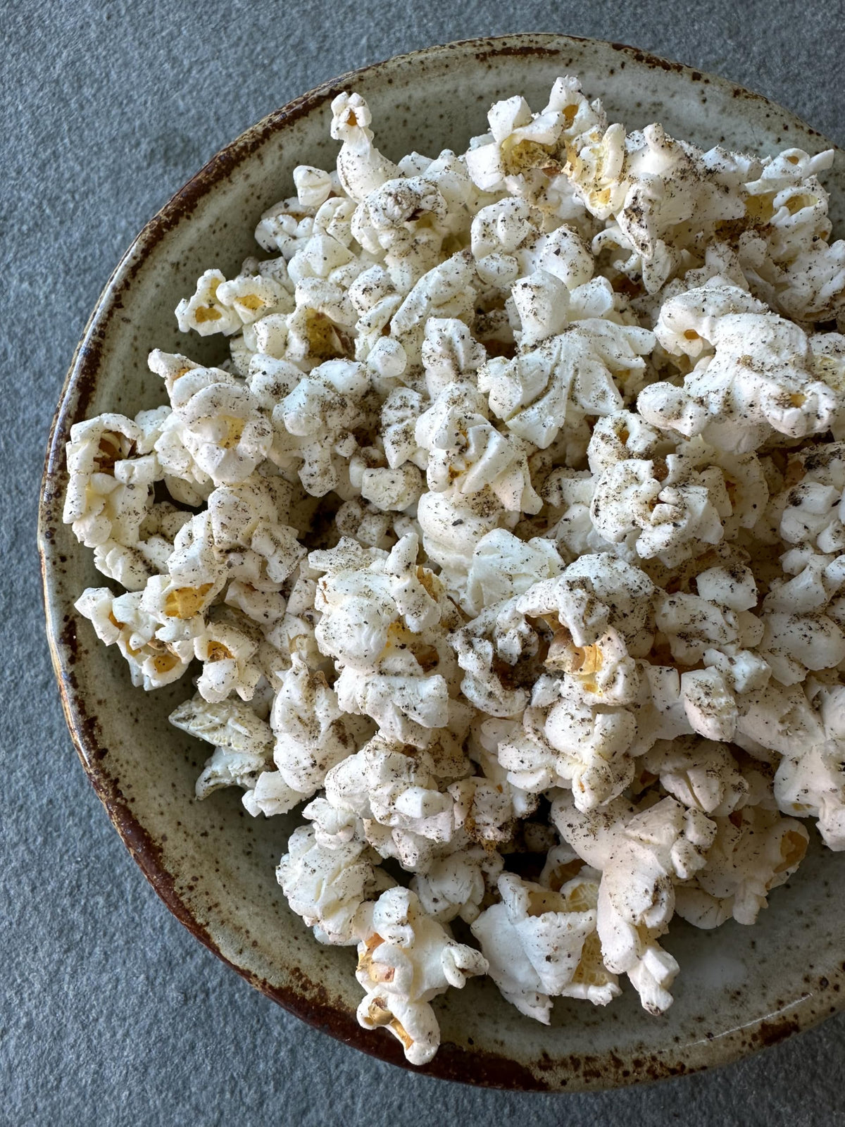 Regalis microwavable black truffle popcorn bag closeup highlighting premium truffle aroma.