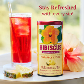 Round natural tea bag resting beside a steaming cup of tea.