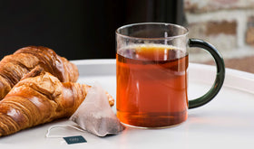 Revolution Tea English Breakfast tin packaging on shelf, inviting premium full-leaf experience