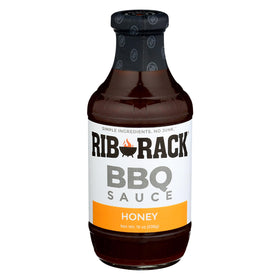 Rib Rack Sweet Honey BBQ Sauce bottle being poured with a glossy glaze over ribs.