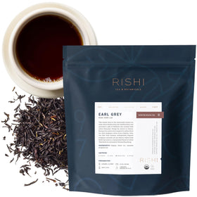 Rishi Tea Earl Grey pack beside a steaming cup, inviting morning ritual.