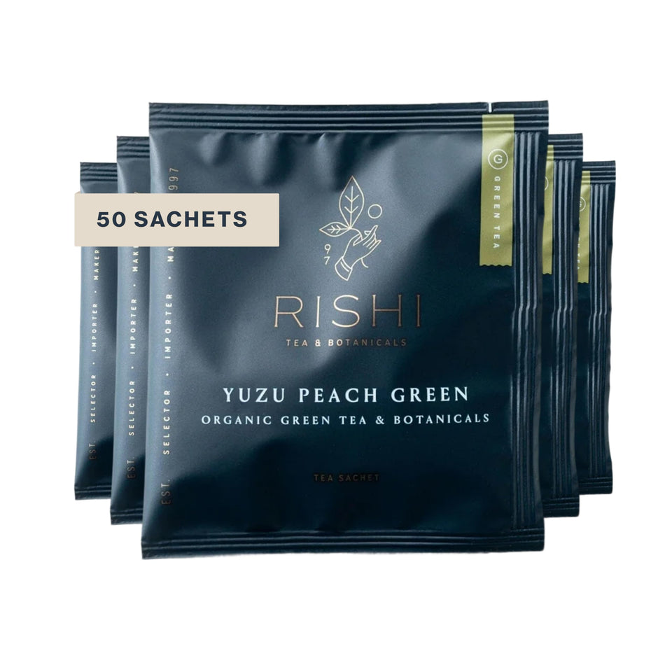 Rishi Tea Yuzu Peach Green Tea packaging highlighting organic ingredients and sustainability.