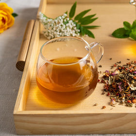Ready-to-serve glass of Rishi Yuzu Peach Green Tea.