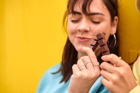 Ritter Sport Alpine Milk Chocolate broken piece reveals creamy interior.