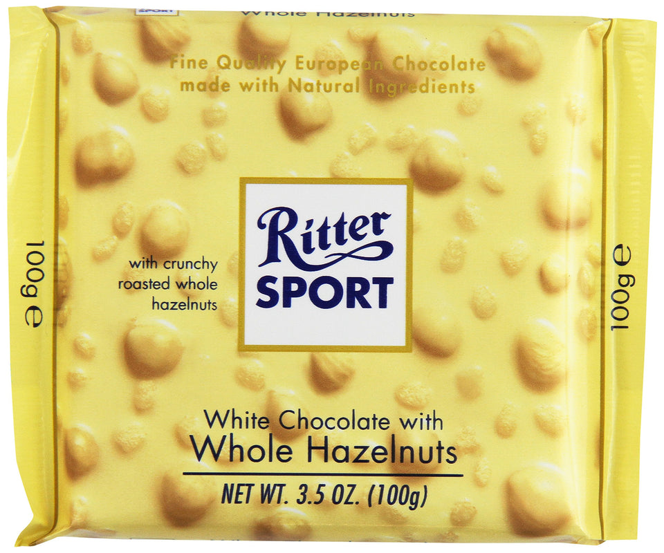 Ritter Sport white chocolate with whole hazelnuts, bar close-up showing creamy melt and crunchy nuts for an indulgent snack.