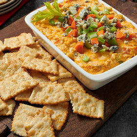 RITZ Toasted Chips at a party with friends for shareable snacking.