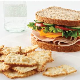 RITZ Toasted Chips Sour Cream and Onion bulk pack on a table.
