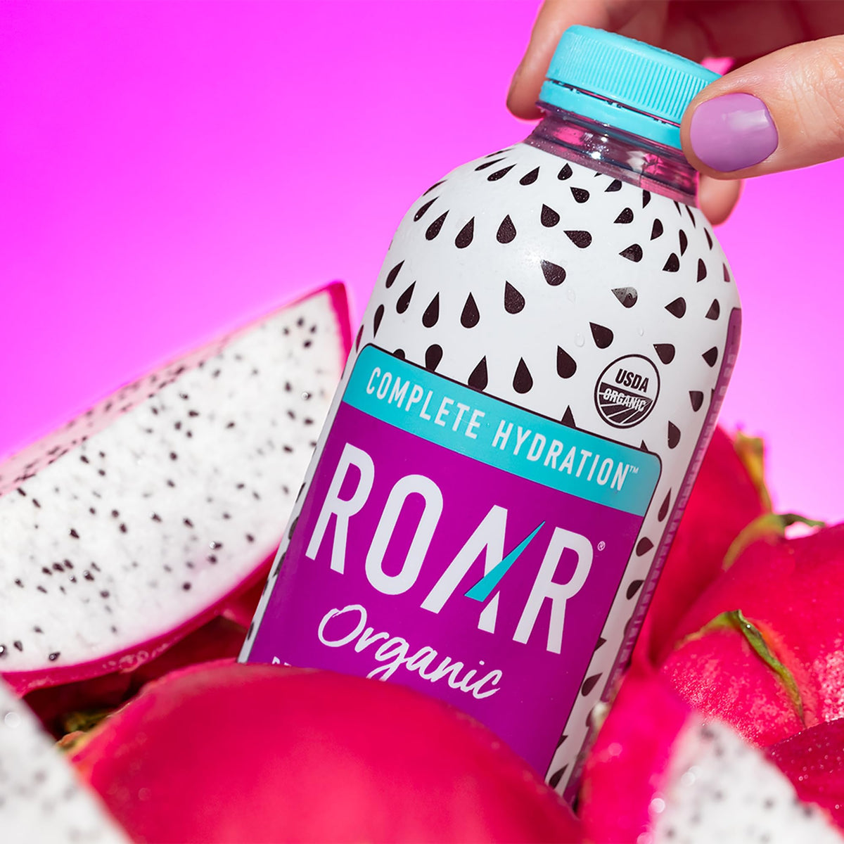 ROAR Complete Hydration Organic dragonfruit punch bottle closeup shows vibrant color
